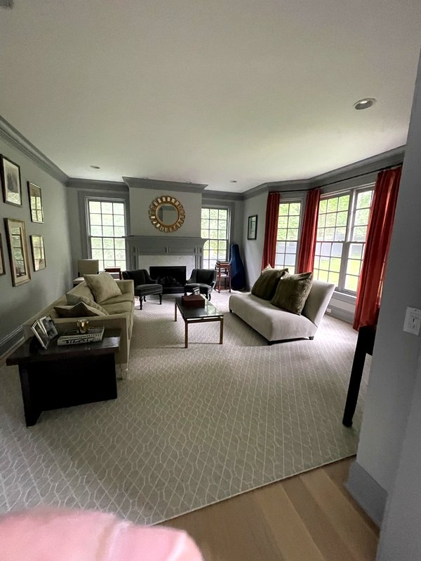 Bright living room with painted walls, bay windows and fireplace