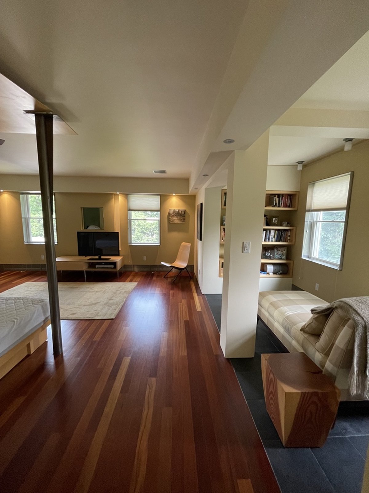 Open concept loft living space with warm paint tones and hardwood floors