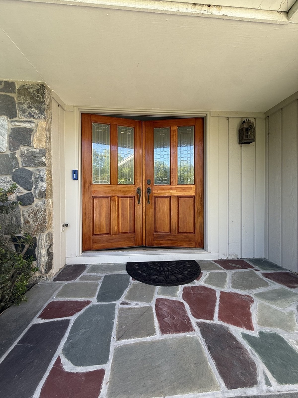 High-performance stained double pine doors with stone and siding